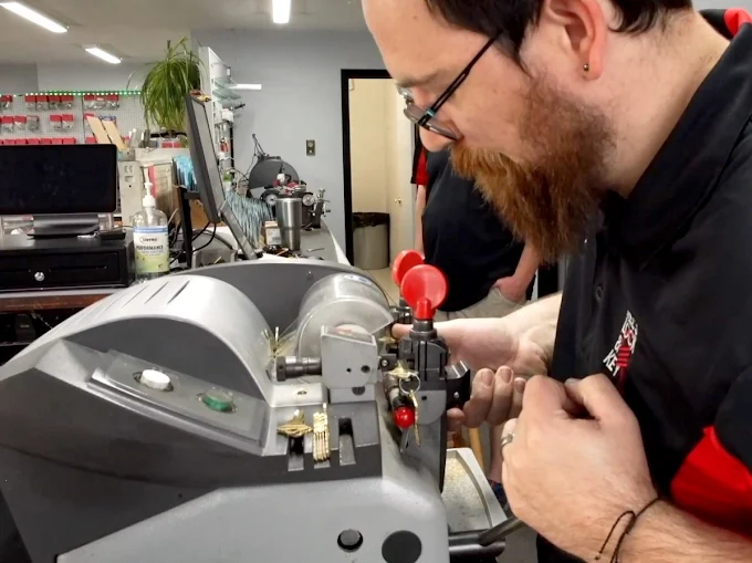 Josh at Mel's Lock and Keys making a copy of a key for a customer